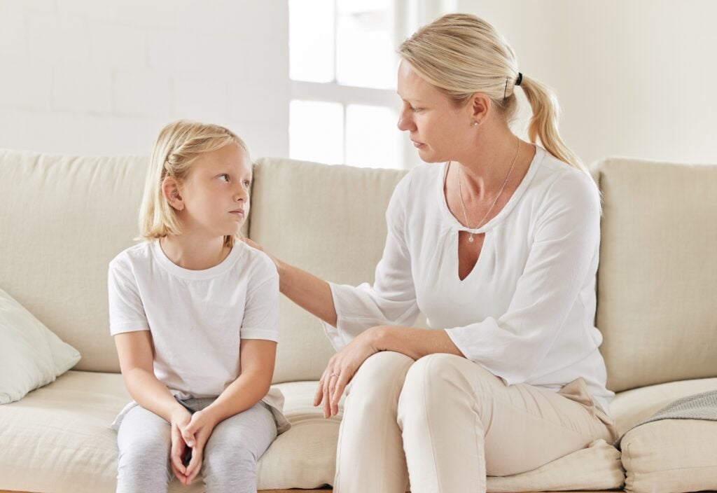 Shot of a young mother comforting her daughter on the sofa at home